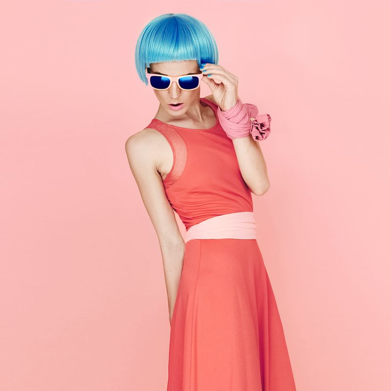 blue haired model with sunglasses in a dress