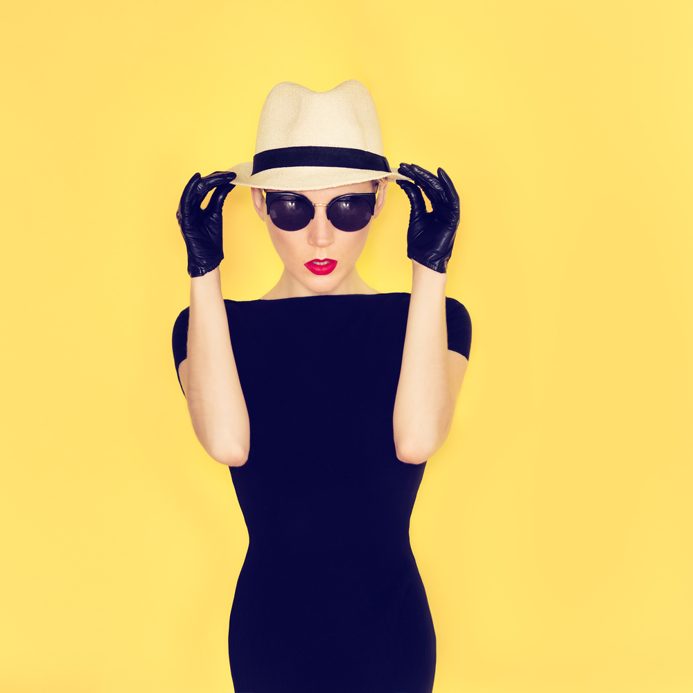 girl in the little black dress on yellow background
